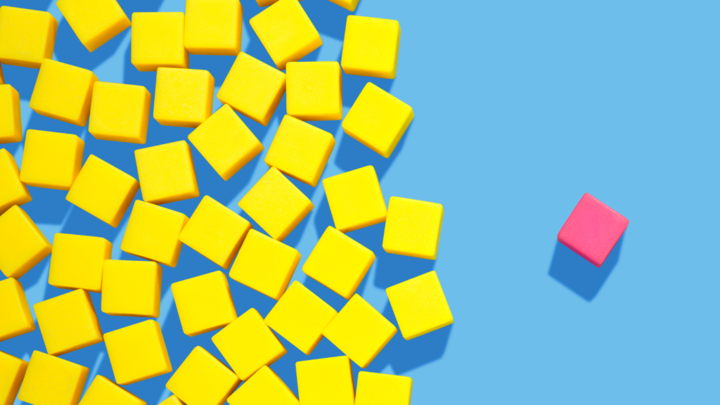Colourful yellow blocks on a blue background with a pink block to the right of them indicating odd one out