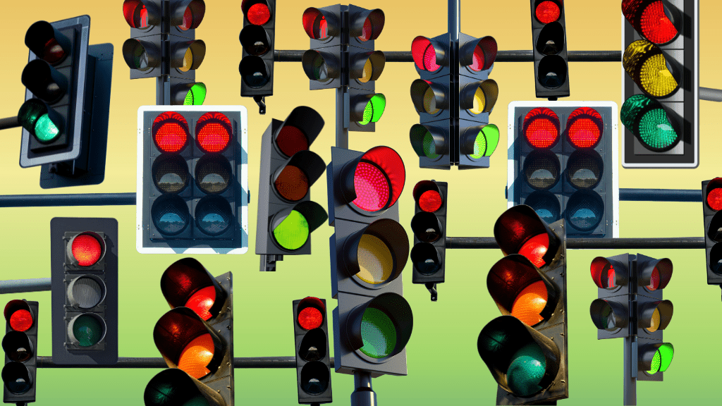 Conflicting traffic light signals on an unnaturally green and red sky.