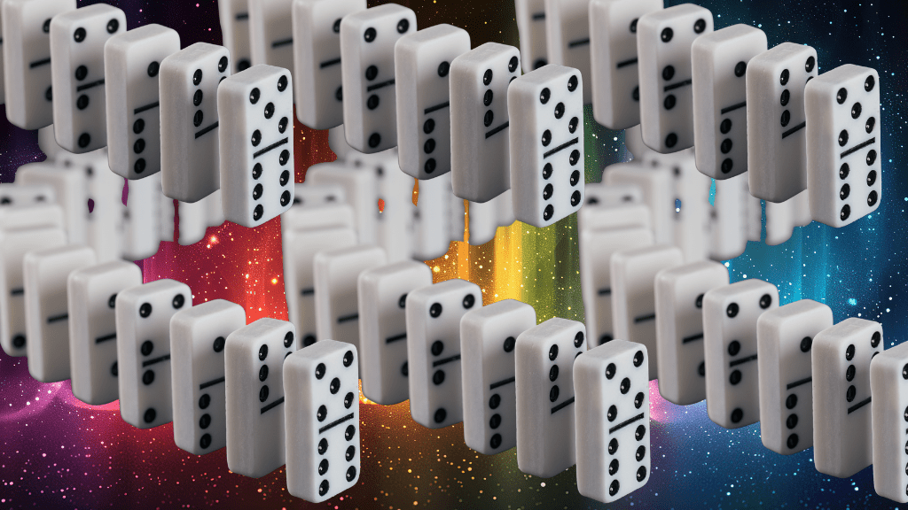 Dominoes all standing in recurring lines over a rainbow glitter backdrop